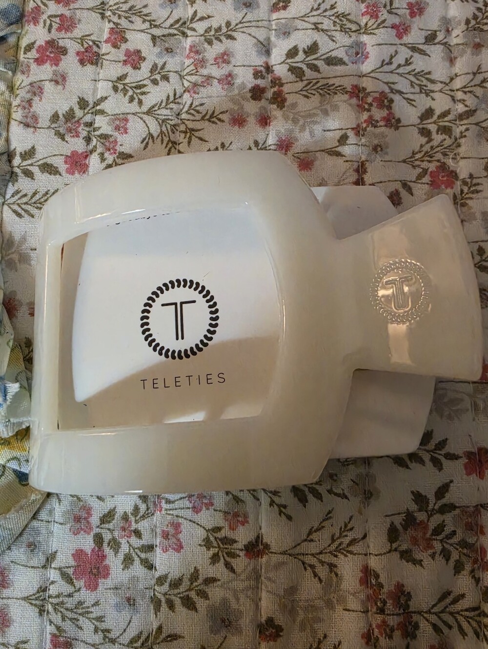 Coconut white plastic hair clip.